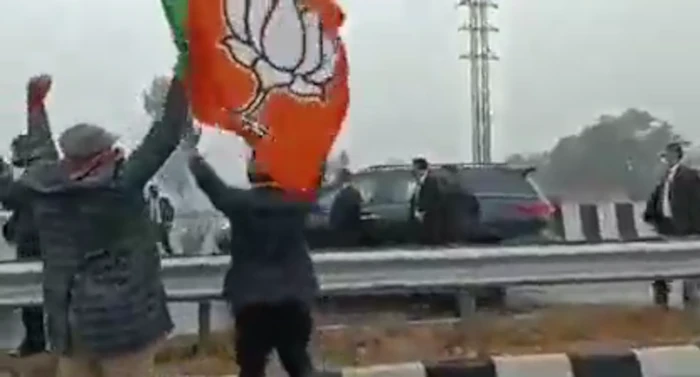 BJP Flag and supporters on the opposite side of the flyover, PM Modi's car in black, Pervez Musharraf