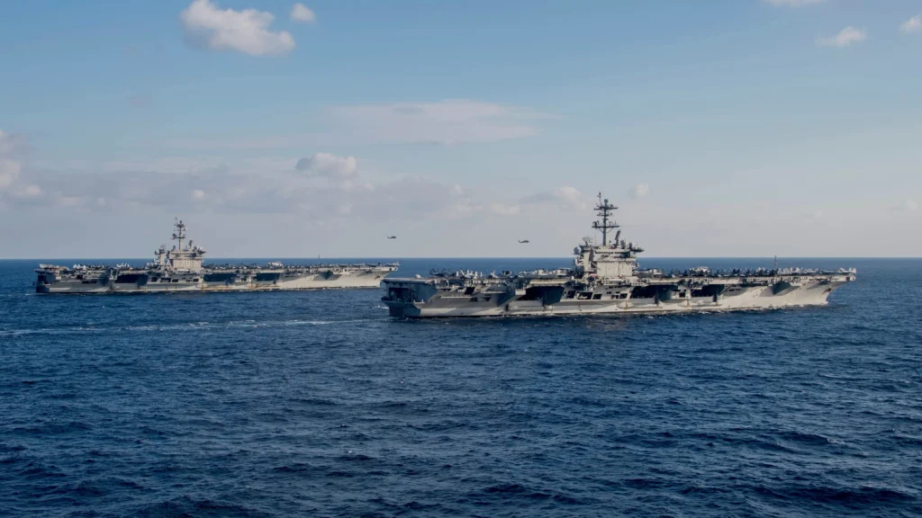 Nimitz-class aircraft carriers USS Carl Vinson (CVN-70), left, and USS Abraham Lincoln (CVN-72) transit the Philippine Sea on Jan. 22, 2022. Image: US Navy 