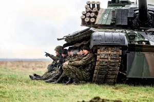 Polish Army personnel rest during a drill
