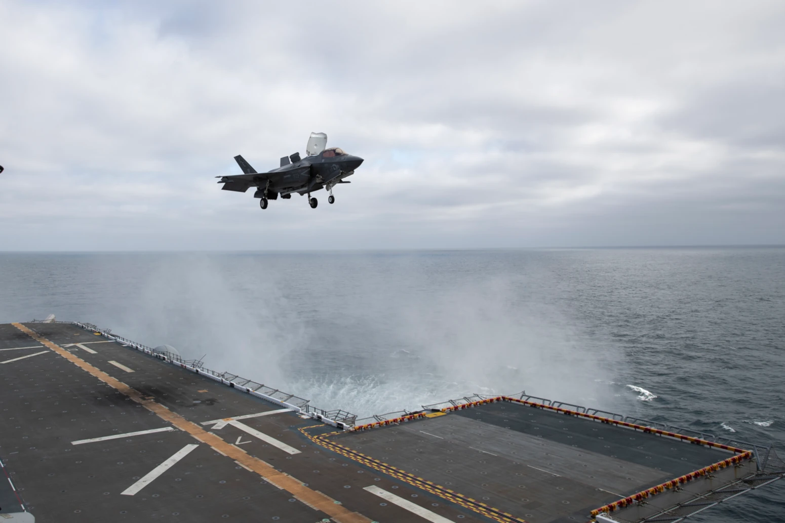 An F-35B Lightning II aircraft attached to Marine Fighter Attack Squadron 225 lands on the flight deck aboard the amphibious assault ship USS Tripoli
