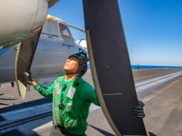 A technician checking aircraft on USS Harry S Truman