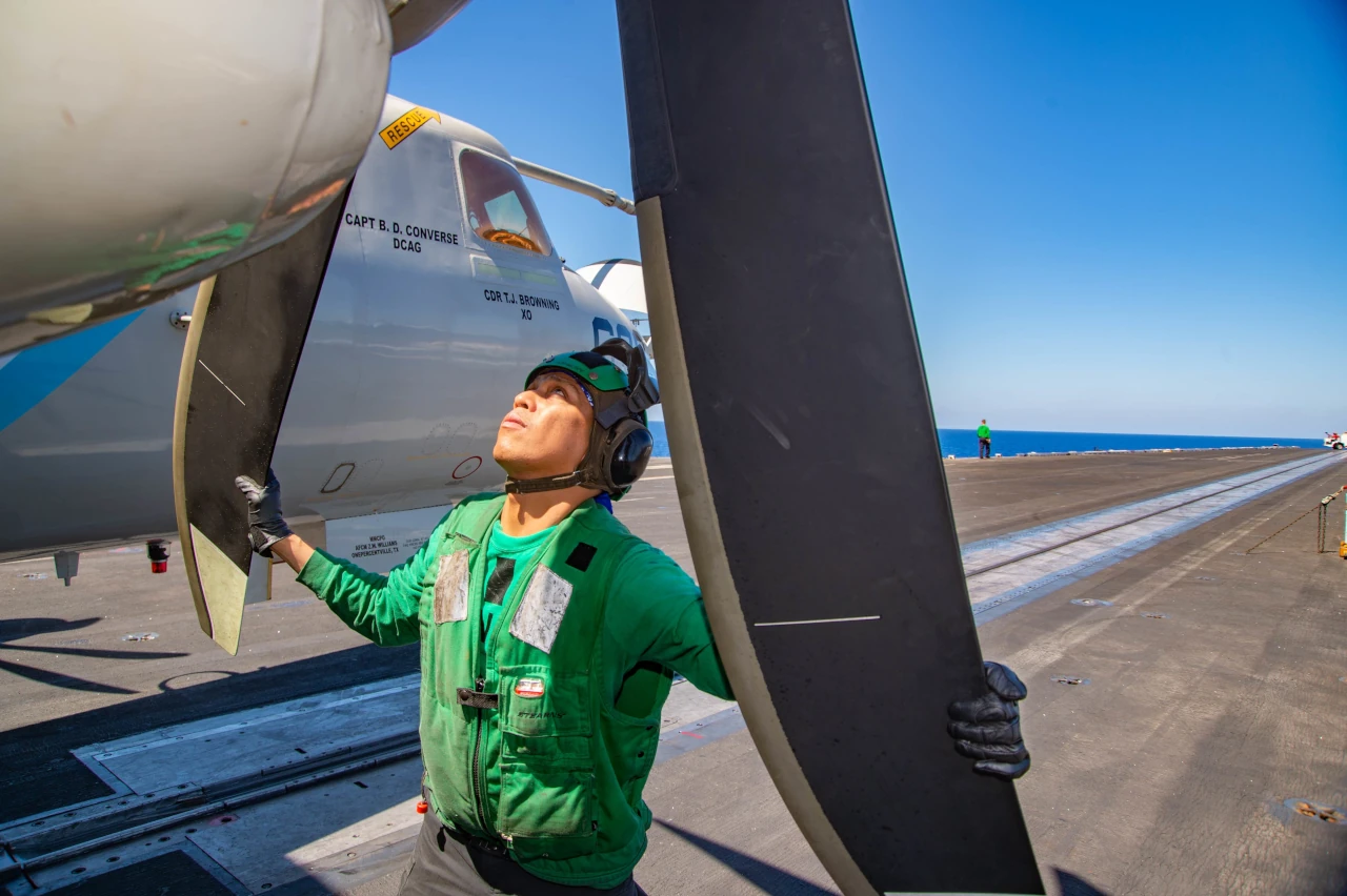 A technician checking aircraft on USS Harry S Truman