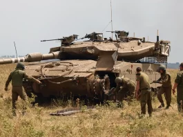 Installation of track on Merkava Mk III tank. Golan Heights.