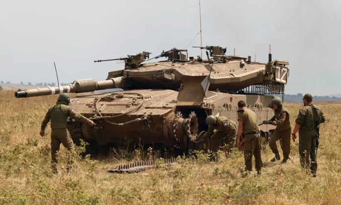 Merkava Mk III tank Installation of track on Merkava Mk III tank. Golan Heights.