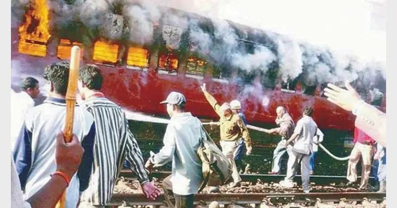 Coach S-6 carrying Hindu pilgrims is engulfed in flames at Godhra, a Muslim-dominated area in the western state of Gujarat