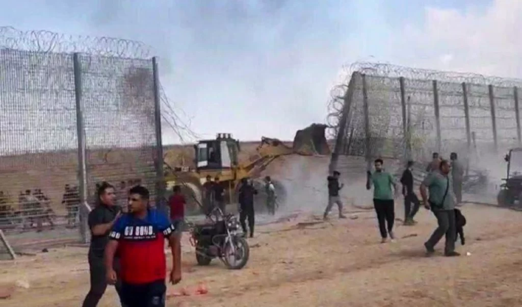Palestinian bulldozers dismantling the border fence on Gaza Border.
