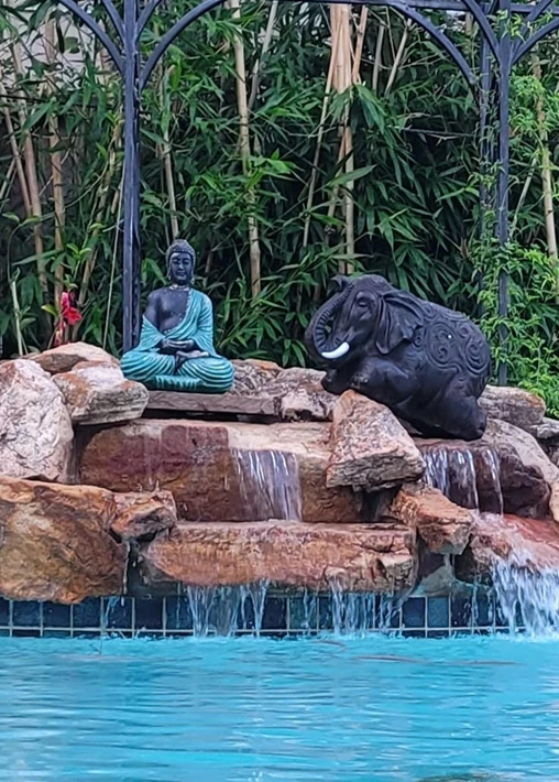 Meditating Buddha atop the rocks at the far end