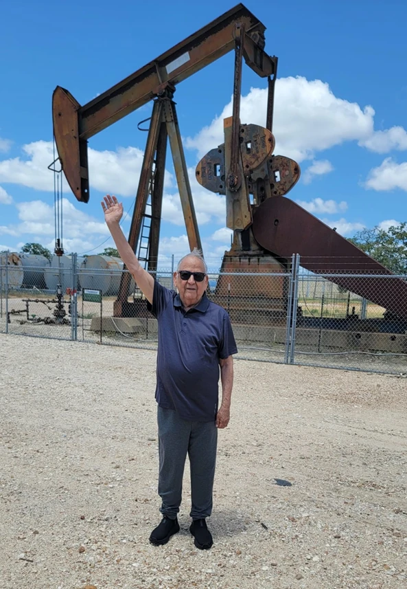 In front of an oil well. Because of its up and down motion, it is nicknamed as the nodding Donkey.