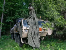 U.S. Army with 5-7 Cavalry, 1st Armored Brigade Combat Team, 3rd Infantry Division camouflage their fuel tanker after taking a defensive position in the tree line during exercise Combined Resolve 25-2.
